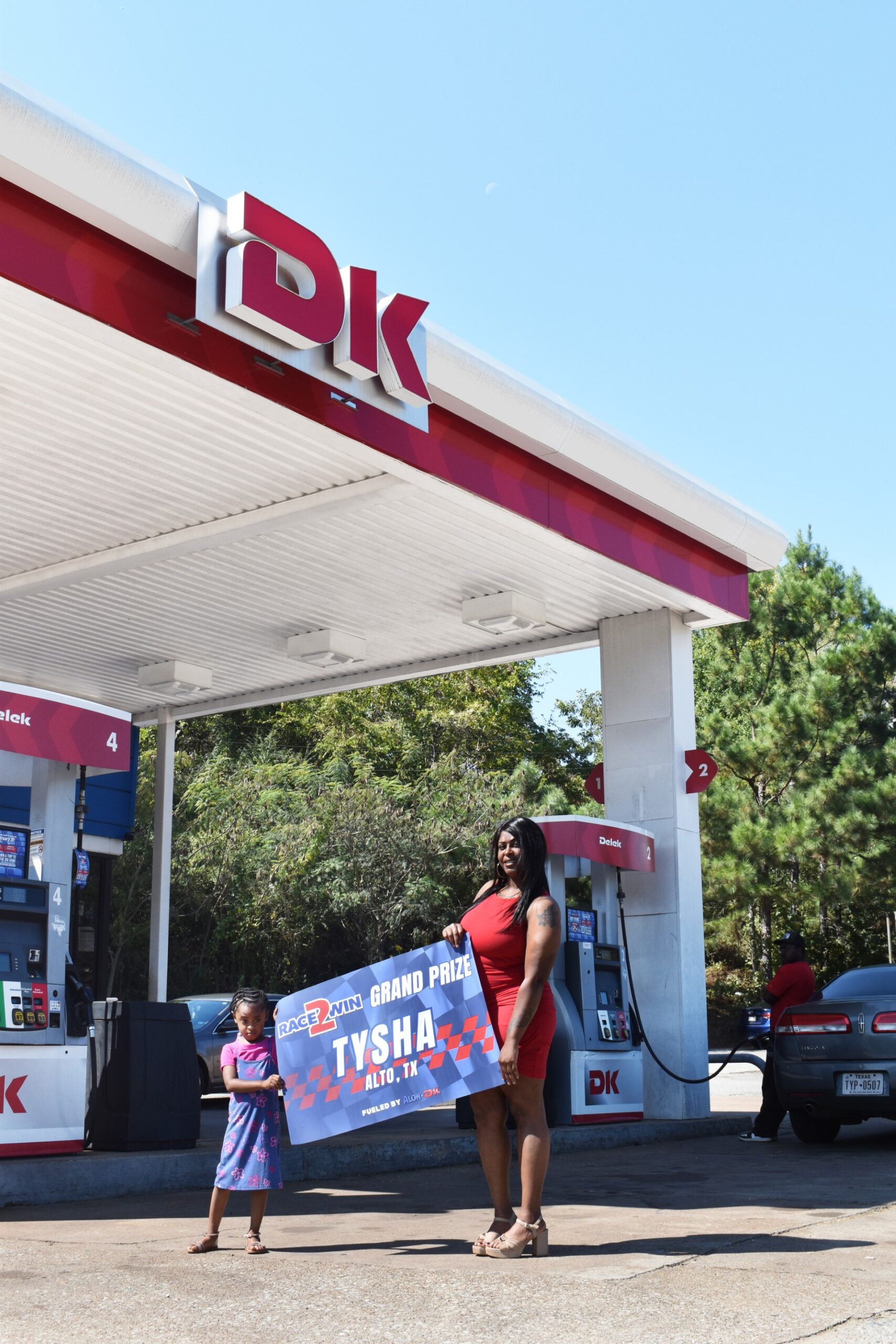 Grand Prize Winner Tysha at Tyler DK Station with her daughter